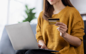 Close up of woman hand using credit card and laptop for payment