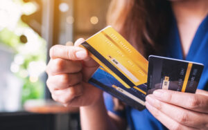 Closeup image of a woman holding and choosing credit card to use