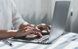 Close up of businessman or accountant working on laptop computer
